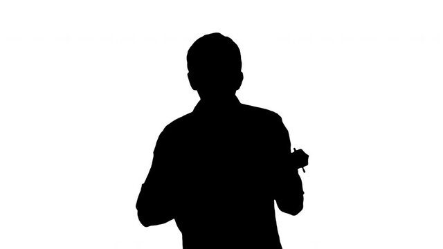 Silhouette Young man playing ukulele while walking.