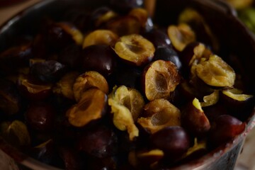 plums cut in a bowl. fruits prepared for cooking. healthy living in the country
