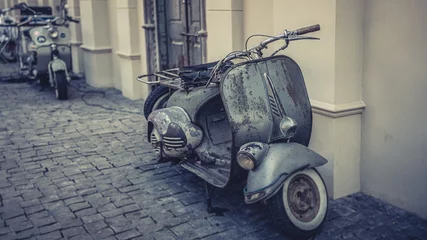 Fototapete Roller Vintage Scooter Parked In The Pavement  © Aris Suwanmalee