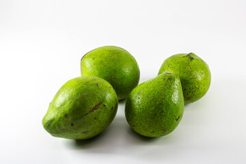 Some fresh green avocado. White Clipping Path. Close-up Avocado. Full depth of field. Isolated on white background. Professional food photography