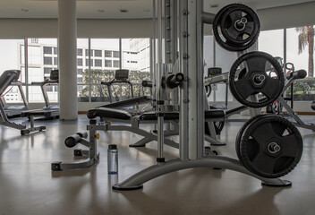 Within gym or fitness studio with modern fitness equipment for fitness events and more. Modern of gym interior with equipment. Sports equipment in the gym. Selective focus.