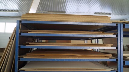Shelves with material for furniture production. Wood for the manufacture and construction of...