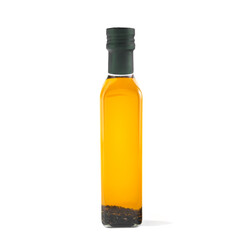 Olive oil with herbs in a glass bottle. White background. Isolated.
