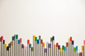 A pattern of colored pencils on the white