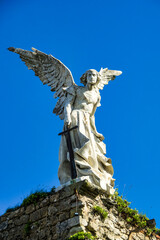 Sculpture of a Guardian angel with a sword in the cemetery of Comillas. Cantabria, Spain