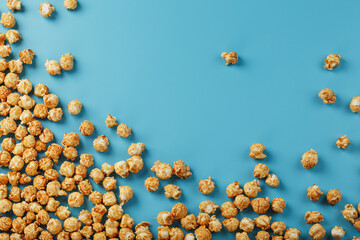 Popcorn is scattered on a blue background, in the form of a frame.