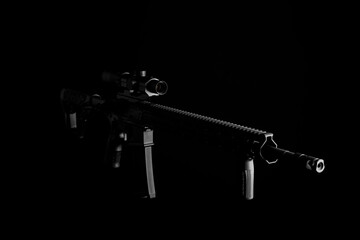 Modern automatic carbine with collimator sight isolate on dark back. Weapons for the army, police...