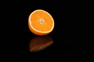 half orange on black background with reflection