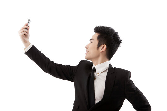 Business man using mobile phone self-timer