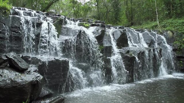 Beautiful waterfall cliff in tropical forest at Namtok Samlan National Park, Saraburi, Thailand - Slow Motion