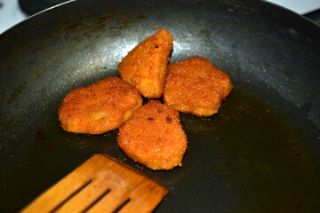 Fried golden chicken nuggets in breadcrumbs close-up