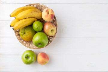 Fruits in a basket over table with copy space