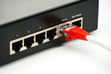 Person plugging in cable to wireless router. Close up.	
