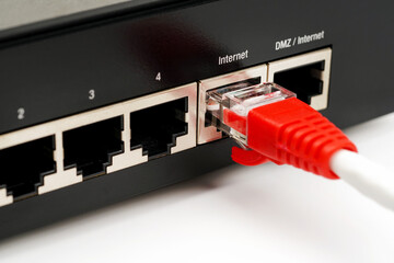 Person plugging in cable to wireless router. Close up.      