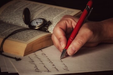 person writing on a notebook