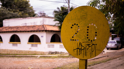 Old train track sign with a house behind