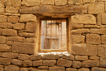 Fototapeta na wymiar Window and house from medieval times, in the town of Uncastillo, in the Cinco Villas region, in the province of Zaragoza, Aragon, Spain.