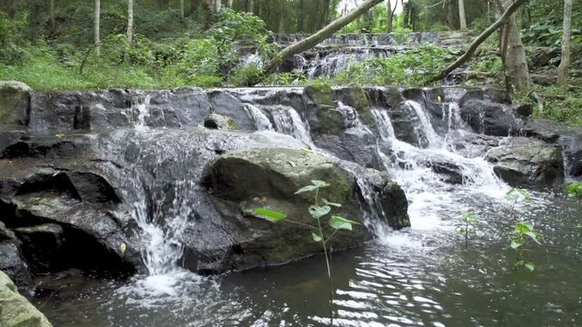 Beautiful stream and waterfall in tropical forest at Namtok Samlan National Park, Saraburi, Thailand - Slow Motion