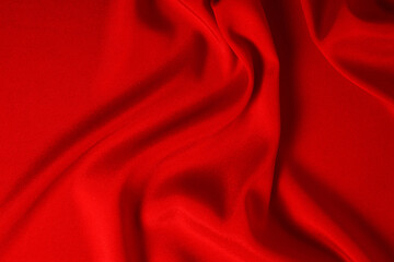 Red silk or satin luxury fabric texture can use as abstract background. Top view.