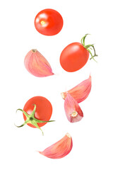 Isolated vegetables. Mixed tomatoes and garlic falling down isolate on white with clipping path as package design element. Full depth of field. Food levitation concept.