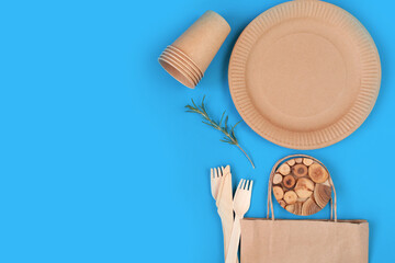 paper cardboard eco dishes on a clean blue background, place for signature