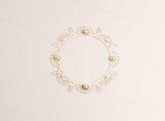 Light beige background with space for writing text with a decorative frame decorated with beads.