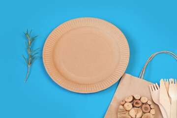 paper cardboard eco dishes on a clean blue background, place for signature