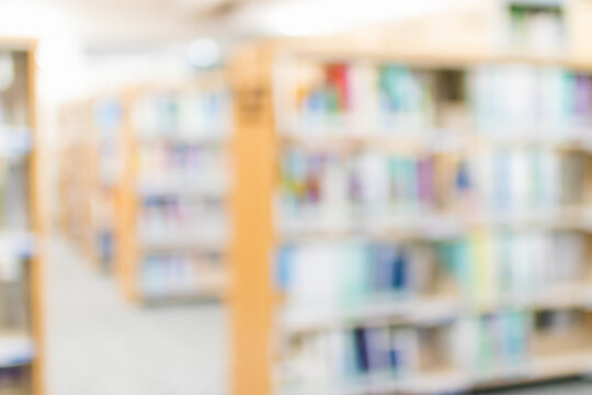 Blurred Image For Background Of Many Books On Bookshelf In Library.