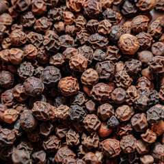 Black pepper beads background. Macro shot. Top view