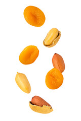 Isolated fruits and nuts. Seven flying peanuts witout shell and dried apricots isolate on white with clipping path as package design element. Full depth of field. Food levitation concept.