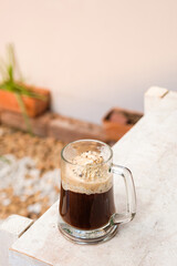 Affogato coffee with ice cream on a glass cup with garden background, Summer Cocktail (close up, selective focus)
