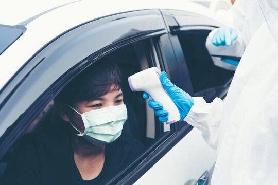 Drive Thru Test Covid19 Fast Track.Medical Worker In Protective Suit Screening Driver To Sampling Secretion To Check For Corona Virus