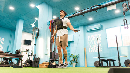 Strong man with tattoos prepares training in the gym to compete