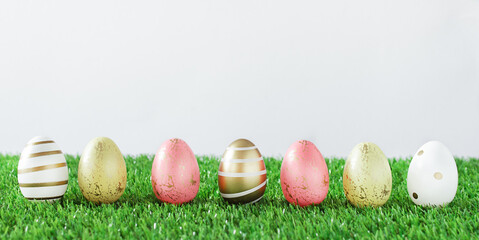 Colorful Easter eggs on grass over white background.