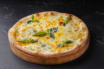 Pizza 4 cheeses on dark background.  Quattro formaggi.