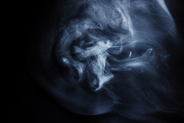 Fototapeta premium Abstract white smoke moves on black background. Beautiful swirling gray smoke.