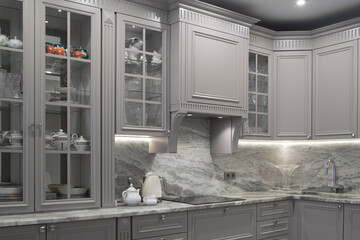 Modern beige and grey colored kitchen interior classic style with marble countertop in luxury...