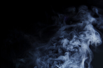 Abstract white smoke moves on black background. Beautiful swirling gray smoke.