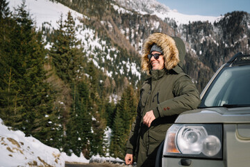 Fototapeta na wymiar person by the car against snowcapped mountain