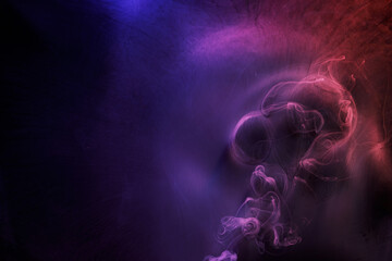 Abstract purple smoke moves on black background. Beautiful swirling smoke.