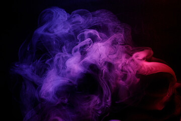 Abstract purple smoke moves on black background. Beautiful swirling smoke.