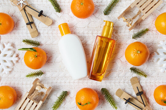 winter flat lay with hair products, snowflakes and mandarins