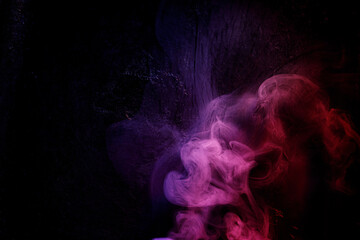 Abstract purple smoke moves on black background. Beautiful swirling smoke.