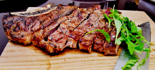 grilled beef steak with knife and herbs