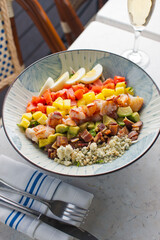 Cobb salad. Classic American restaurant or French bistro Cobb salad, made with chopped Bibb or Romain lettuce, heirloom tomatoes, bacon, blue cheese, avocado, hard boiled eggs tossed with olive oil.