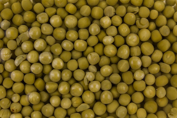 a lot of canned green peas in water in a bowl