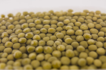 a lot of canned green peas in water in a bowl