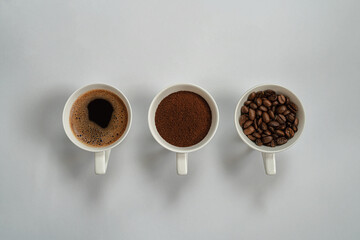 cup sof fresh brewed coffee ,beans and ground coffee .copy space.top view