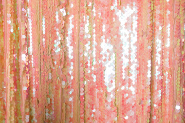 peach shiny glitter fabric. textural background. sequins