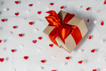 gift box with red ribbon on the background with hearts Valentine's Day, birthday gift, mother's day concept